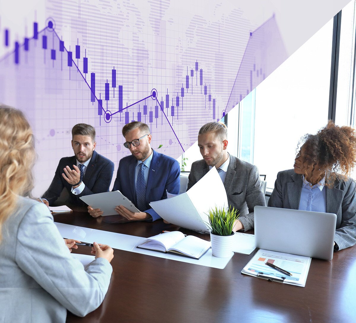 Business meeting with five professionals discussing financial data, with a purple graph visualization in the background showing data trends
